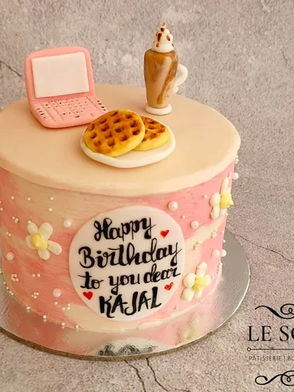 You name it, I can craft it in fondant. This half-kg cake features adorable miniature fondant waffles, a pink laptop, and a milkshake for a personalized birthday theme.