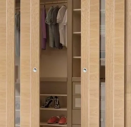 A sliding wardrobe with light wood panels, offering a clean and minimalist look that fits well with Scandinavian or modern interiors.