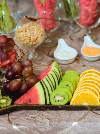 Our fruit platters are a work of art. Here, we've carefully sliced and arranged kiwi, watermelon, and oranges alongside fresh grapes, creating a colorful and healthy addition to any buffet.