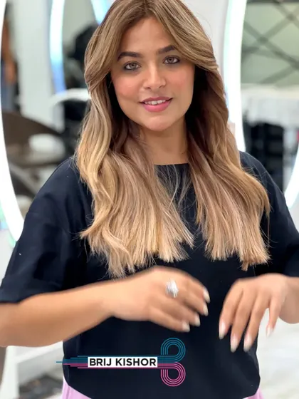 A beautiful shot of this creamy peach ash blonde balayage. The color is a unique blend of warm and cool tones.
