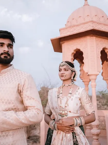 A duplicate of image 90, this photo captures a confident and regal pose from the couple, with the palace architecture adding to the majestic feel.