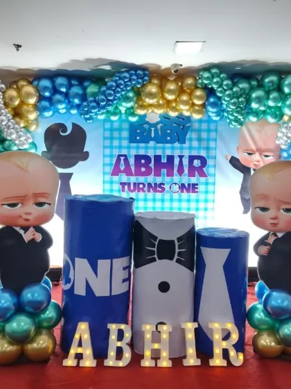 The full Baby Boss theme setup with character cutouts and marquee letters in front of the custom backdrop.