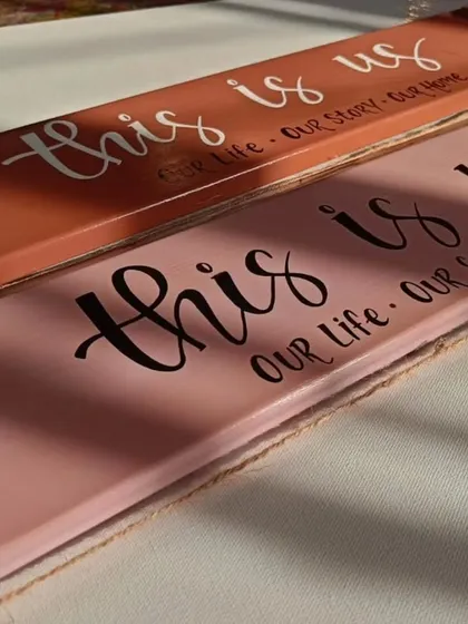 Our hand-painted photo clippers are a heartfelt addition to your home. This "this is us" design, in a warm cinnamon and rose palette, is perfect for clipping on memories and loving messages.