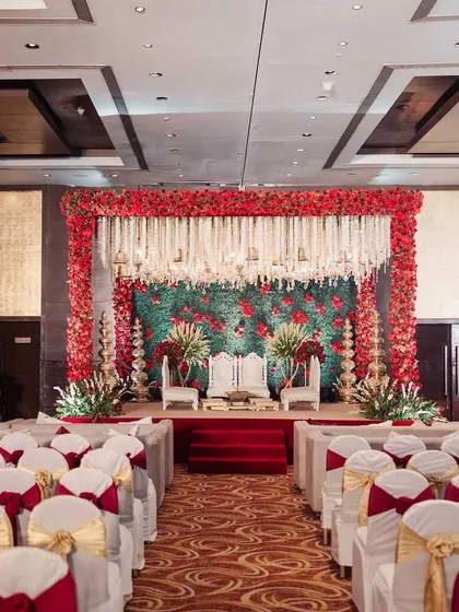 For a touch of royal elegance, I created this Sabyasachi-inspired mandap. The design features a rich palette of red florals against a green foliage wall, with traditional tuberose hangings, embodying timeless Indian luxury.