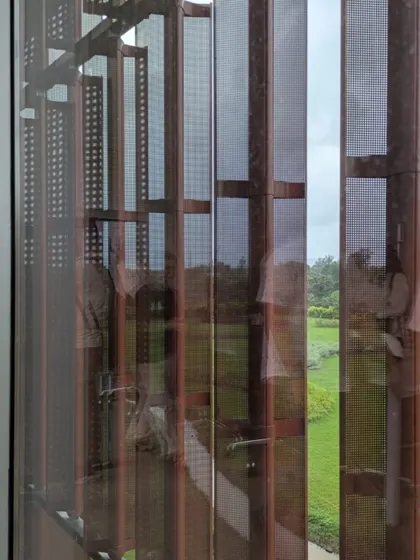 A detail of the perforated metal screens at the JSW Vasind office, seen during a team walkthrough. These on-ground sessions give our designers a deeper understanding of how our design concepts perform in reality.