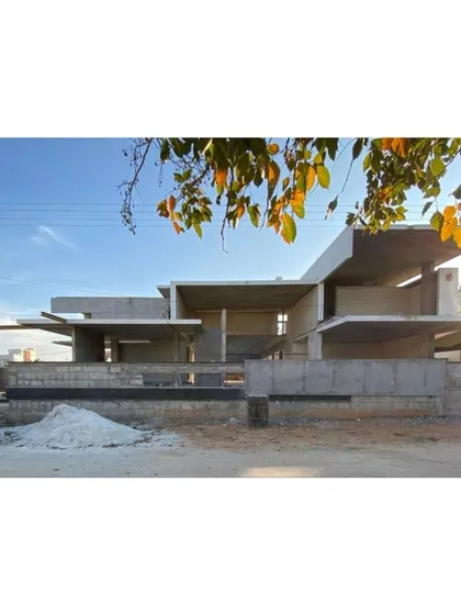 This image shows the bare structure of The Quarry House during its construction phase. It reveals the complex engineering and formwork required to achieve the project's ambitious cantilevers and sculptural masses.