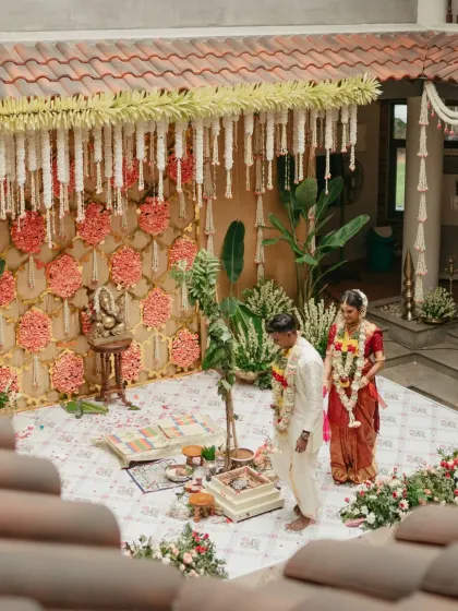 For this Tamil wedding, we created a vibrant floral backdrop using traditional patterns and colors. The Ganesha idol stands as a centerpiece, blessing the union in a space that feels both sacred and full of life.