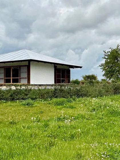 The Umbrella House sits gently in its new landscape in Germany. It is a testament to the idea that great architecture, though rooted in its original context, can possess a timeless and universal quality.