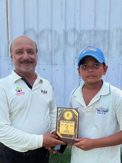 Vansh Rawat looking proud as he receives his Man of the Match plaque. It's these moments that build a young player's confidence.