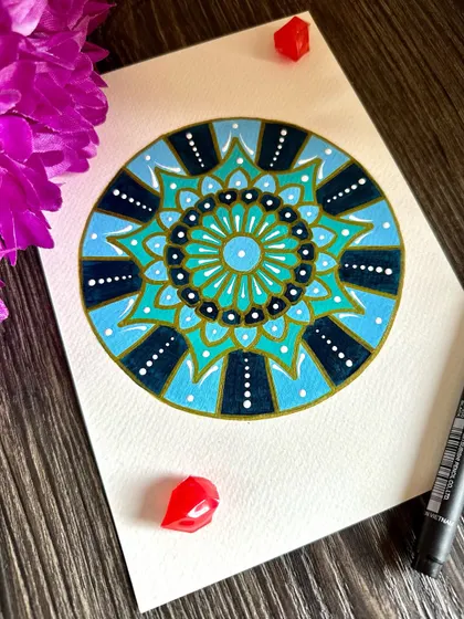 Add some mandala calm to your day. This design uses shades of blue and gold to create a feeling of calm and sophistication.