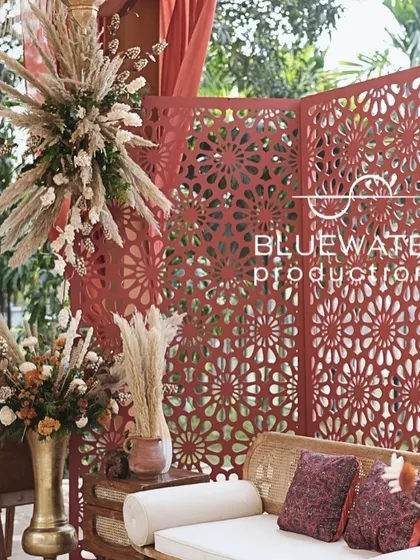 A close-up of the red jaali screen and rustic seating, part of the Dubai Souk Mehendi decor.