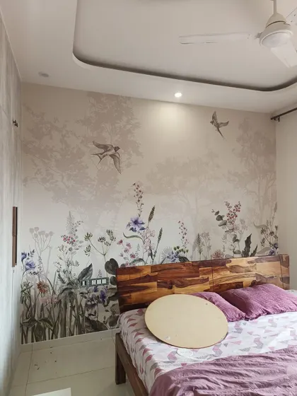 A wider view of the wildflower mural, showing how it complements the wooden headboard and bedroom furniture.