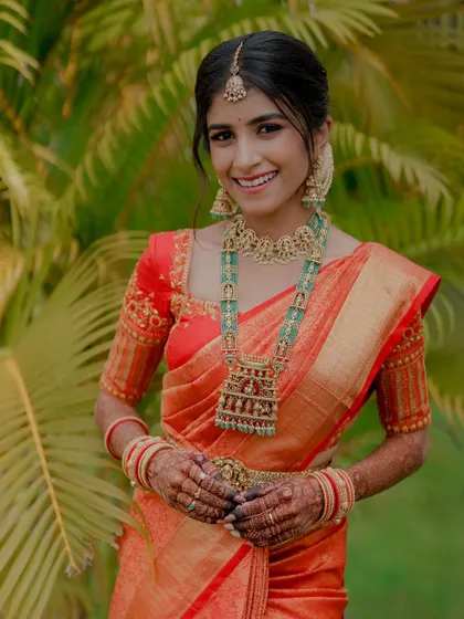 A radiant smile from the bride, her temple jewelry and custom blouse completing the look.