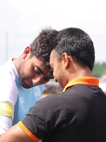 A moment of connection and strategy between two players. I encourage my players to communicate and support each other on the field.
