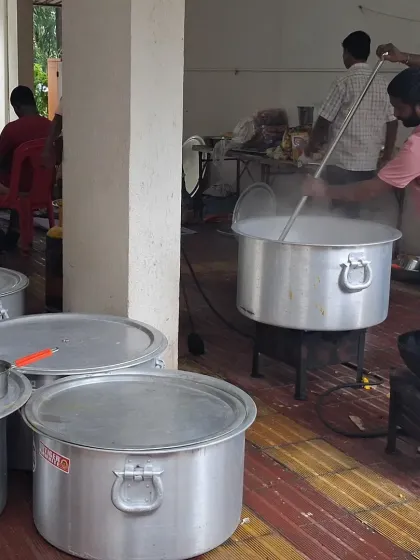 This is a glimpse of our kitchen during preparation for a large Bhandara. We use large pots to cook fresh food on-site, ensuring everything is hot and tasty for your guests.