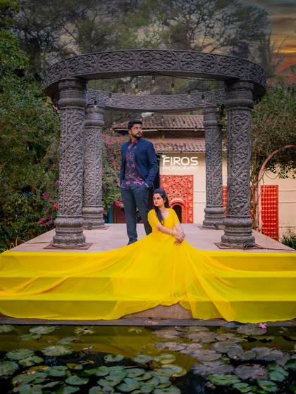 A vibrant and sunny portrait at the stone structure. The bright yellow gown spreads across the steps, creating a cheerful and eye-catching contrast with the dark stone.