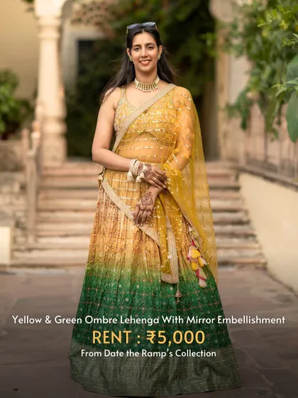 This yellow and green ombre lehenga with mirror work is a unique and eye-catching choice for Navratri.