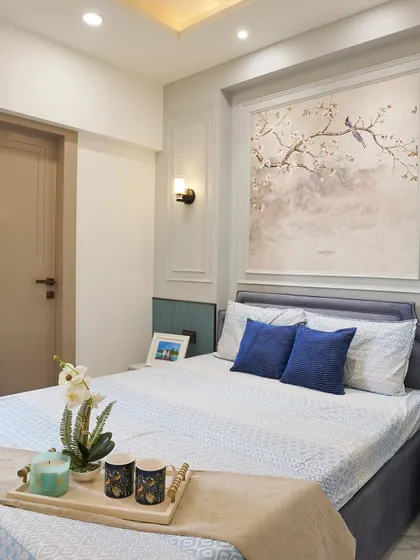 A corner view of this peaceful bedroom, showing the simple door design and the soft, calming color palette. The artwork above the bed adds a touch of elegance.