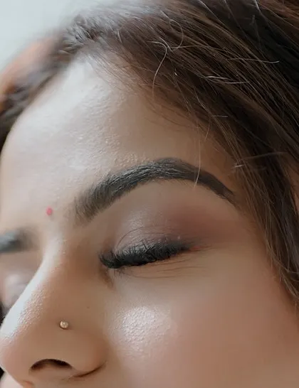 A detailed look at a soft, natural eye makeup application. The brows are defined and the eyeshadow is subtly blended for a clean, everyday glam look.