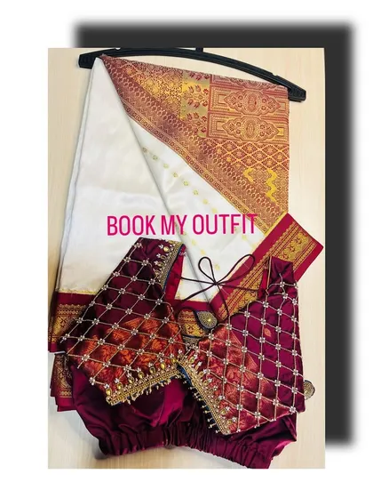 This set pairs a classic off-white and red silk saree with a custom-stitched maroon velvet blouse. The blouse's quilted beadwork adds a rich texture that beautifully complements the traditional weave of the saree.