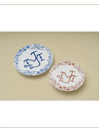 A closer look at the custom monograms that blend Dutch and Indian art styles, printed on elegant coasters.