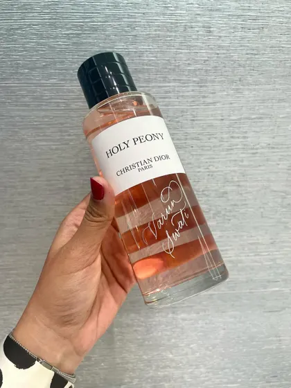 Holding a freshly engraved Holy Peony fragrance bottle during the Dior Diwali event. Each name is carefully etched to create a simple, elegant, and personal gift for the client.