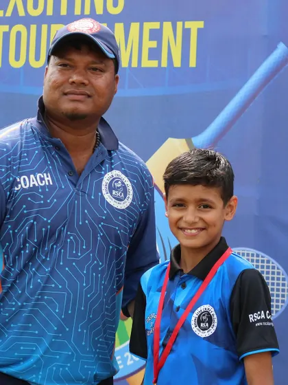 A coach and a young player with his medal pose for a photo at the RSCA Dasara Cup presentation.