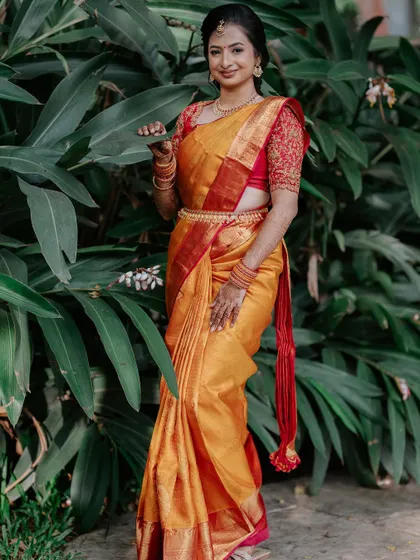 A portrait of pure elegance. This bride's look is defined by soft, shimmering eyes and a flawless base, set against a stunning backdrop of yellow flowers.
