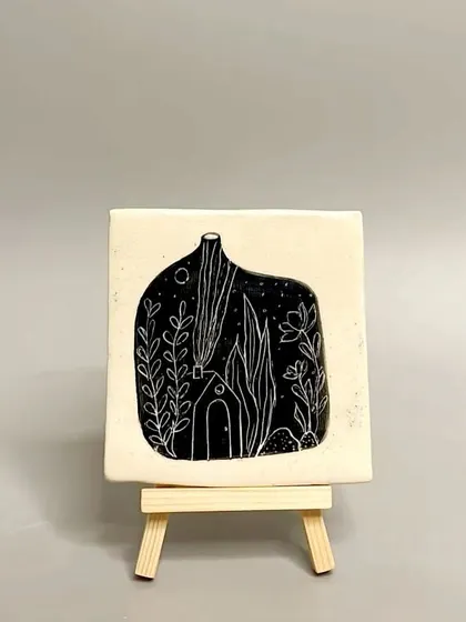 This square tile features a whimsical scene of a house at night, carved using the sgraffito technique. It's a perfect little piece of art for a side table or shelf.