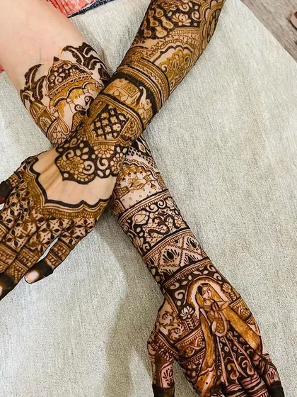 This design showcases two different narrative styles. One arm features a bride portrait, while the other has a more traditional layout with elephants and jharokhas.
