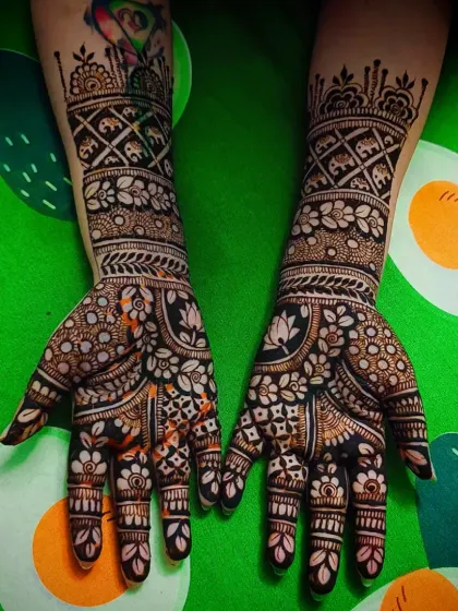 This design is filled with traditional Indian motifs, including elephants and lotuses, set against a backdrop of intricate floral and geometric patterns.