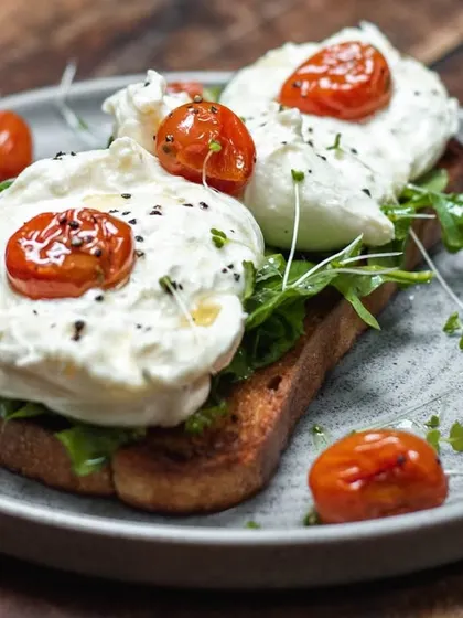 A closer look at our burrata toast. The creaminess of the cheese pairs perfectly with the sweetness of the tomatoes and the crunch of the bread.