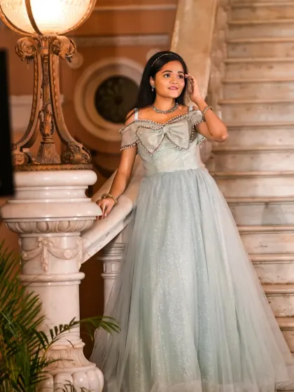 Posed on a grand staircase, this blue ballgown looks absolutely magical. It's the perfect dress for a fairytale-themed event.