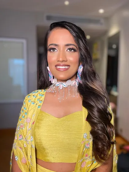Deepanshi looks fresh and vibrant for her Haldi ceremony. The makeup is minimal yet effective, letting her natural beauty shine.