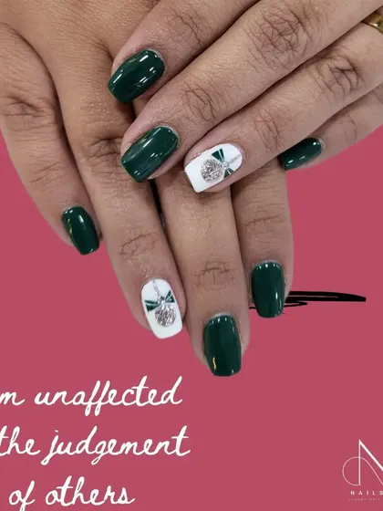 "I am unaffected by the judgement of others." This chic dark green manicure with a white and silver bow accent is for the confident individual.