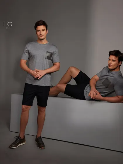 This look elevates everyday casuals with refinement. A simple grey t-shirt with a contrasting pocket detail is paired with black shorts for a stylish and comfortable outfit.
