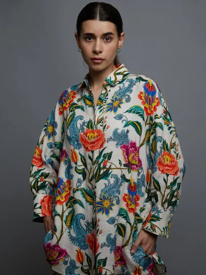 A full view of the printed shirt dress. This is a perfect catalog shot that clearly shows the product while maintaining a high-fashion feel.
