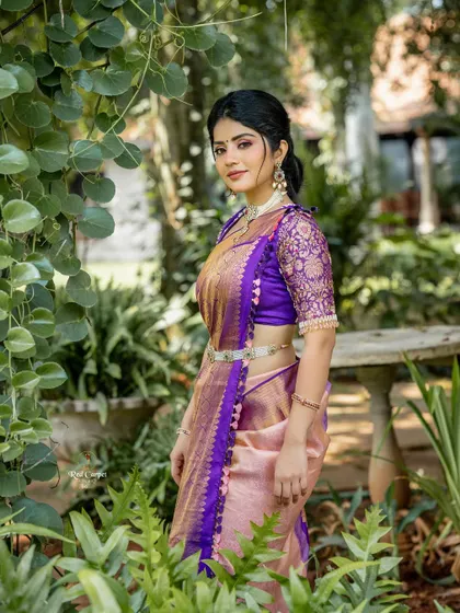 A classic pose from Megha Shetty, highlighting the rich color and texture of the saree and the exquisite craftsmanship of the blouse.