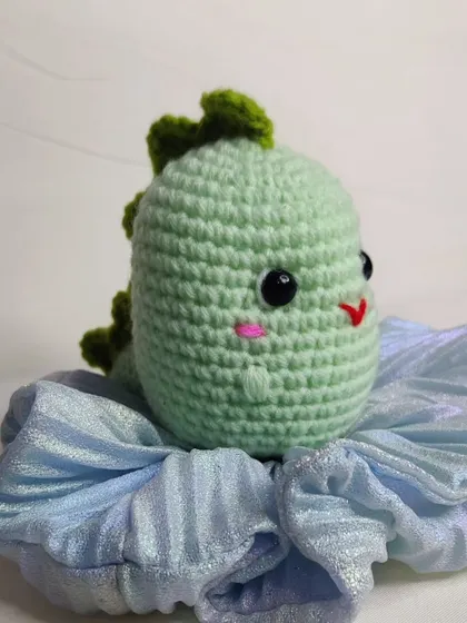 A mint green dino keychain.