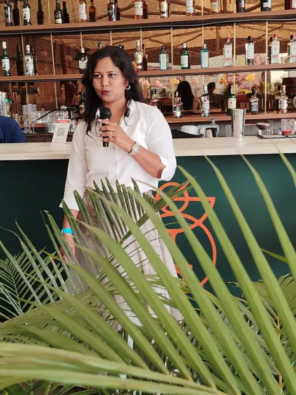 Hosting from the bar area at a stylish venue. I can adapt to any event layout, ensuring my voice and energy reach every guest, no matter where they are.