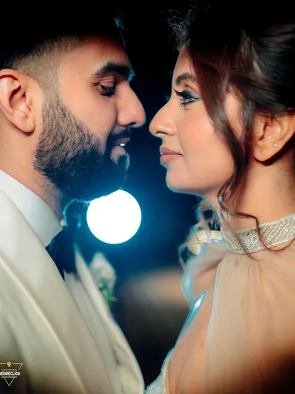 An intimate close-up where the focus is entirely on the couple's connection. The soft background light highlights their profiles, creating a romantic and dreamy mood for this engagement portrait.