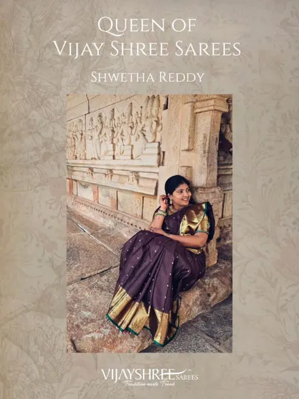 Shwetha Reddy looking like royalty against a heritage backdrop, draped in a deep wine-colored Kanjivaram with a striking gold border.