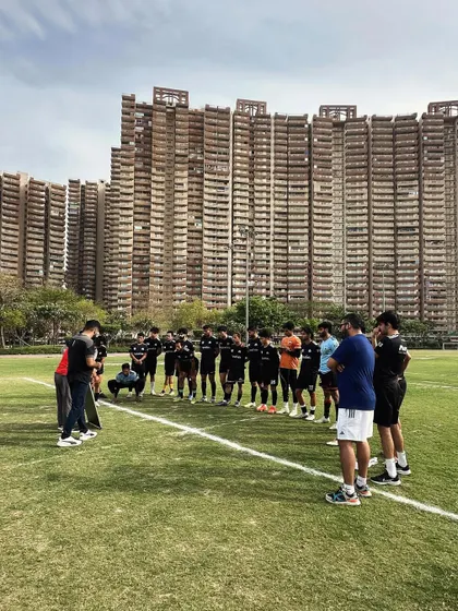 United by a single mission. Our senior team huddles before a match, with the city we represent as our witness. This is the Wolfpack, standing strong as the Pride of Noida.