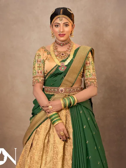 A full view of a bride in a half-saree, adorned with a complete temple jewellery set. This shows how versatile my rental pieces are for different traditional outfits.