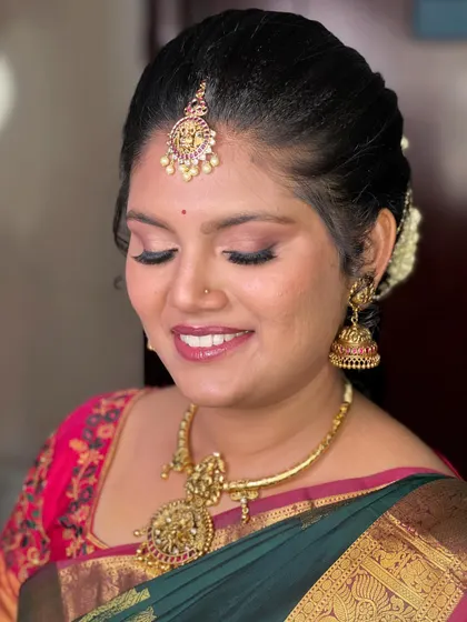 A close-up showcasing the soft pink tones on the eyes and lips, which perfectly complement the pink in her saree's border.