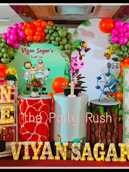 Viyan Sagar's "Wild One" party was a vibrant and colorful jungle celebration. The decor includes a mix of bright and earthy balloons, animal print plinths, and a variety of jungle animal cutouts.