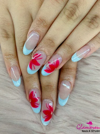 A beautiful contrast of colors. This set features a modern French manicure with soft blue tips, with accent nails showcasing bold, hand-painted red flowers. It's a fresh and artistic take on a classic style.