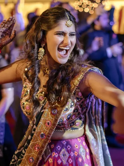 Pure energy! Sneha dancing the night away at her sangeet. This photo perfectly captures the fun, vibrant spirit of her look.