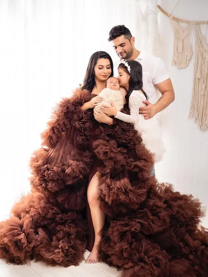 A stunning family portrait featuring a dramatic, flowing gown. This photo shows how we can create high-fashion looks for your family session.