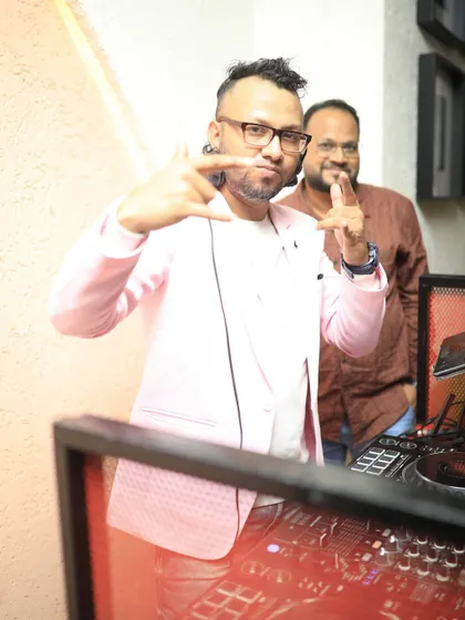 Posing for the camera while in the DJ booth. It's important to have fun and connect with the crowd, even while focusing on the music.